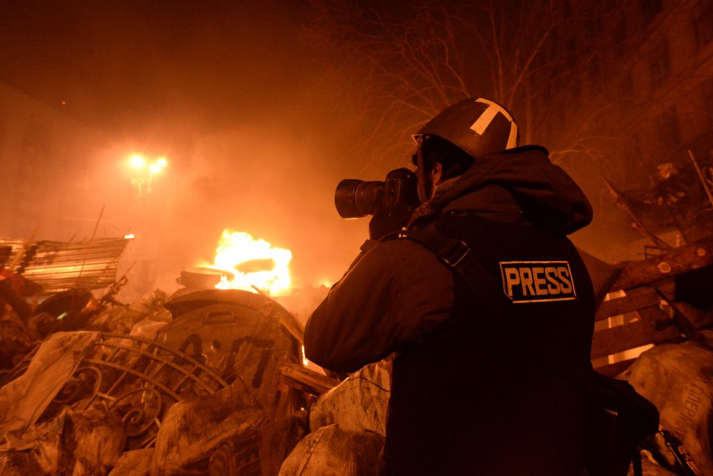 A journalist documenting events at the Independence square in Ukraine. Although newsworthy events like this still get wide coverage by traditional print, TV, and radio, the reach and real-time access provided by emerging new media technologies are slowly 