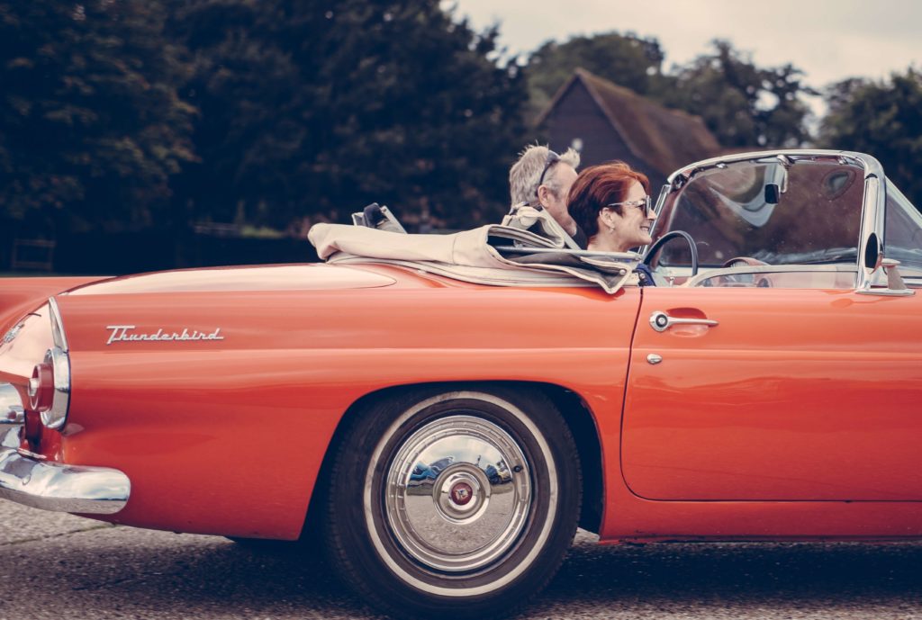 retirees in vintage car