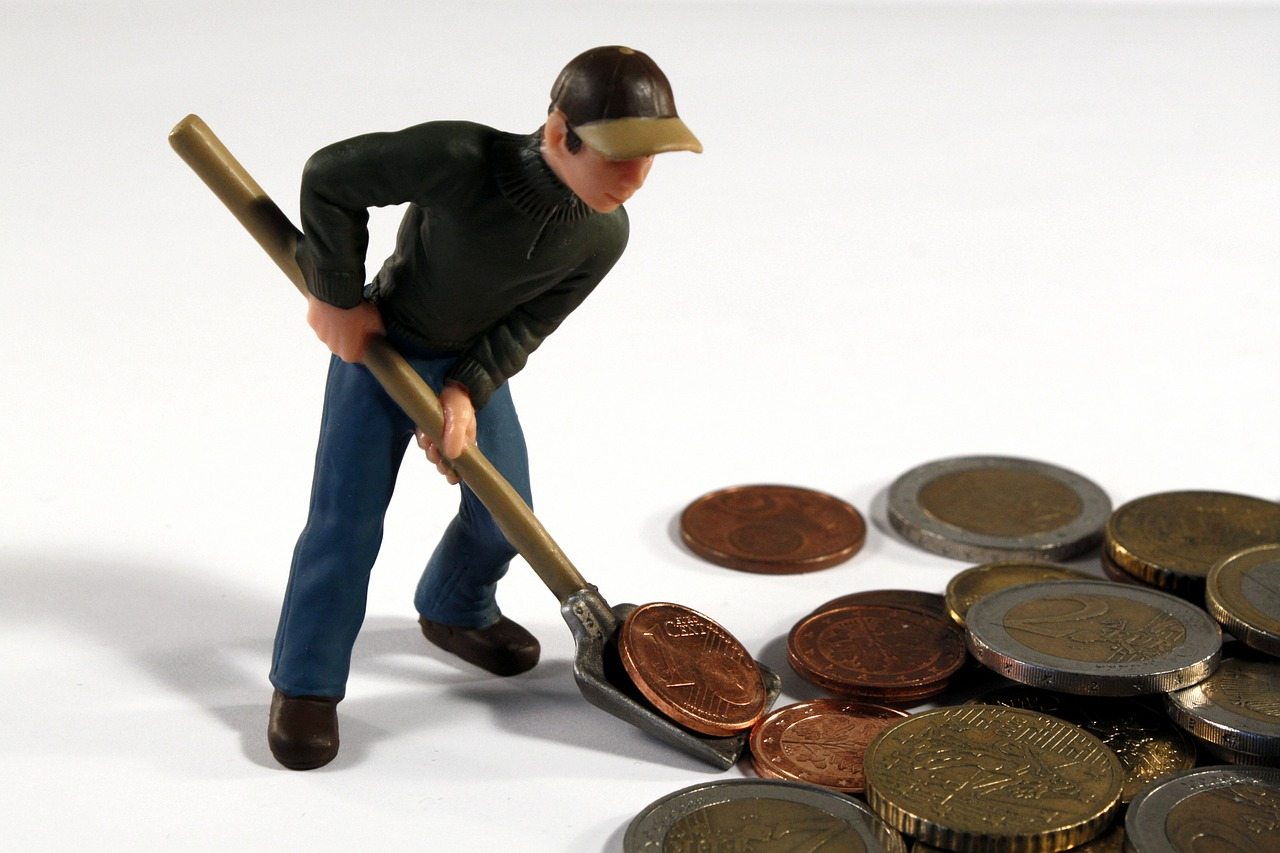 toy figure shovelling coins