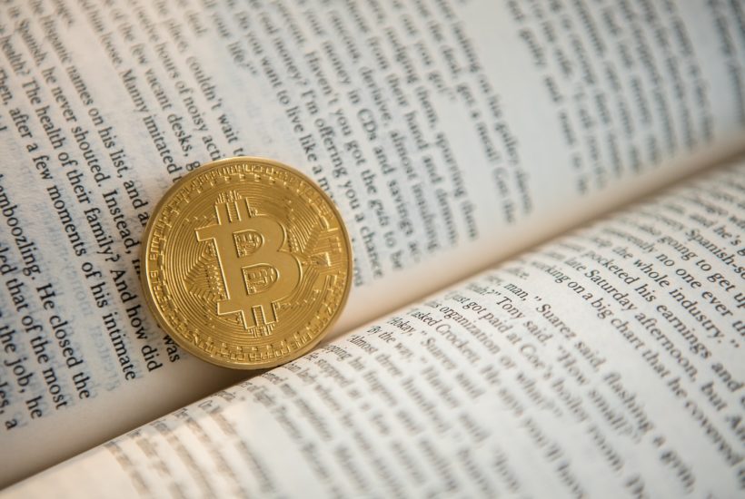 This picture show a bitcoin inside a book.