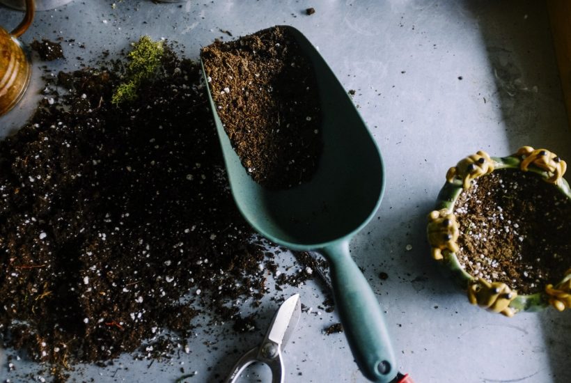 This picture show a shovel lifting some dirt.