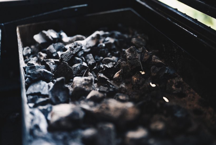 This picture show a lot of coal in a cart.