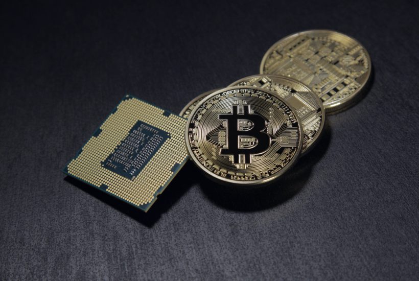 This picture show a bitcoin and a processor, represent crypto services