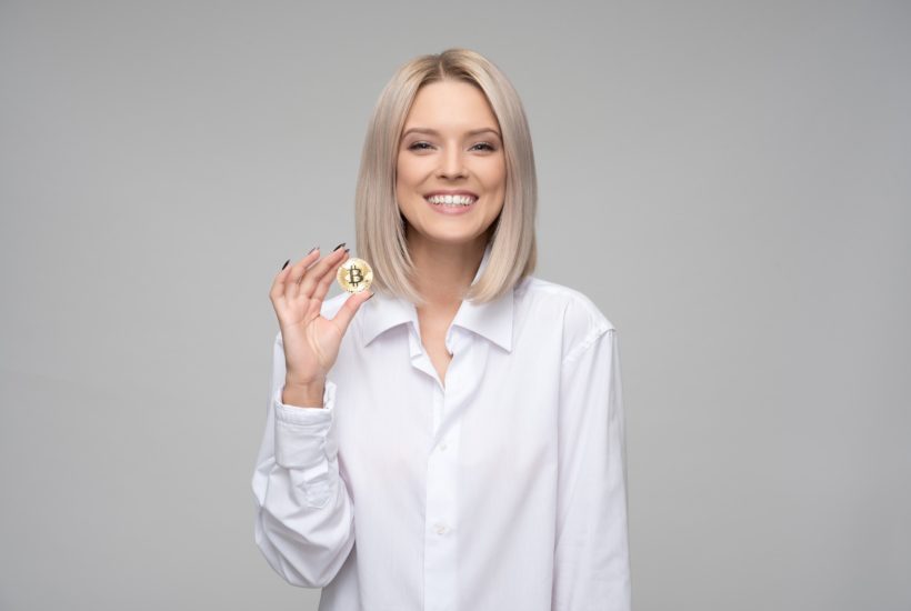 This picture show a person holding a bitcoin.