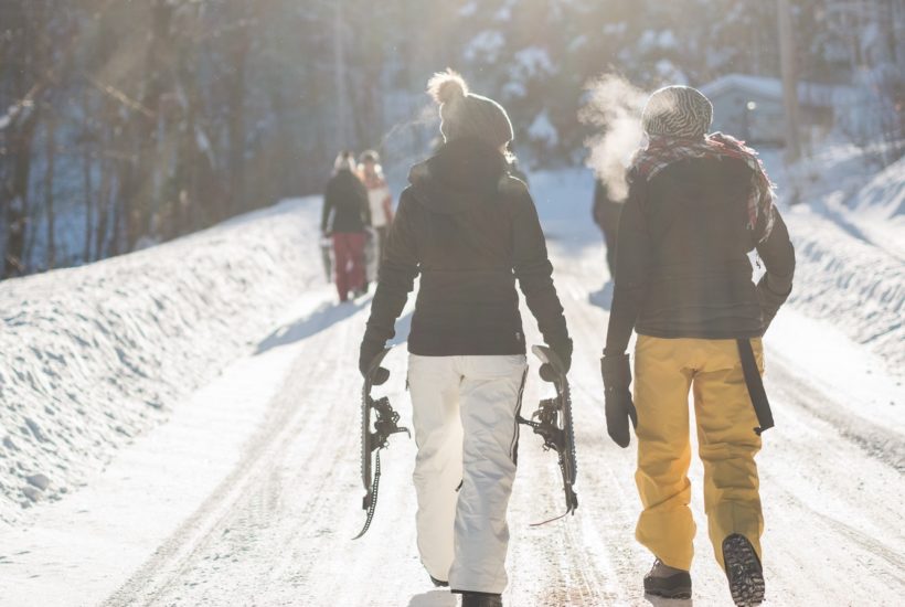 This pictures show two person skiing representing the smallest skis in the world.