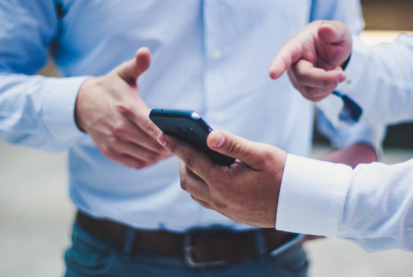 This picture show a man using a smartphone.