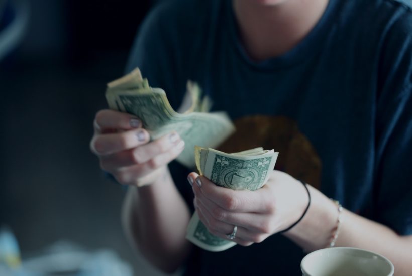 This picture show a person counting money.