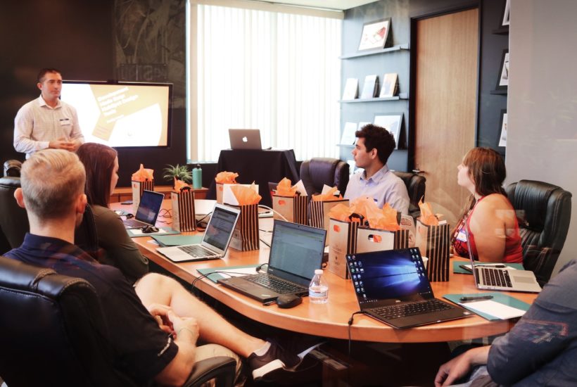 This picture show a group of people in a conference room.