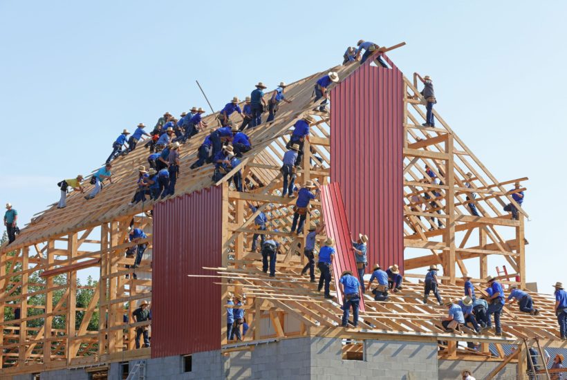 This picture show a group of people building a house.