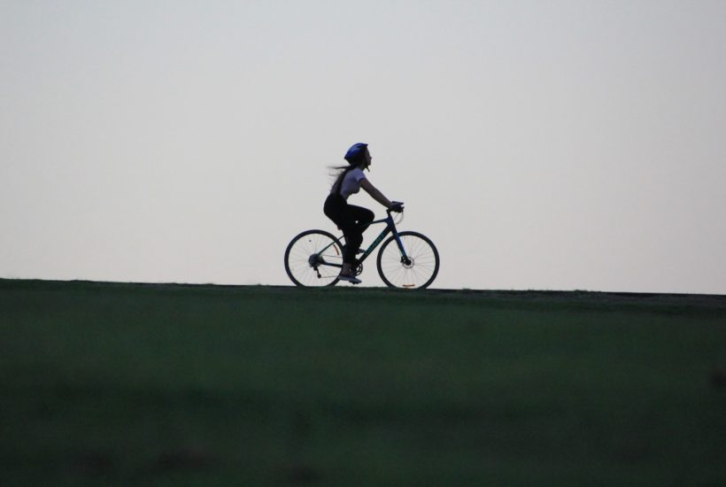 This picture show a person riding an electric bicycle.