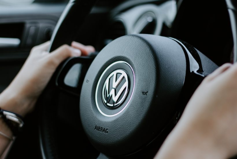 This picture show a person holding a Volkswagen wheel.