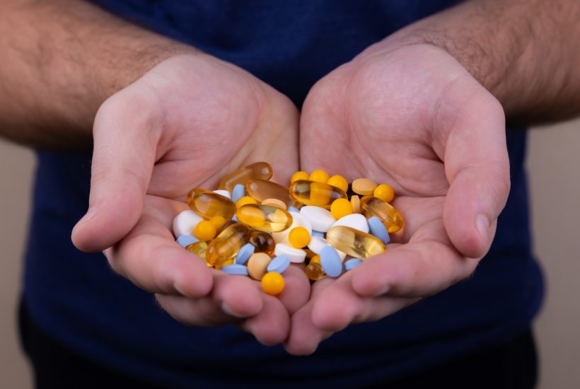 This picture show a person holding some medical capsules.