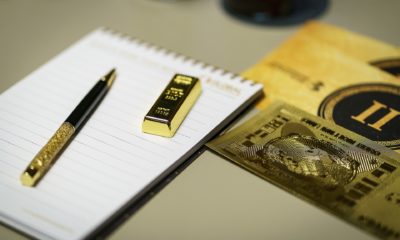 This picture shows a gold bar on top of a notepad.