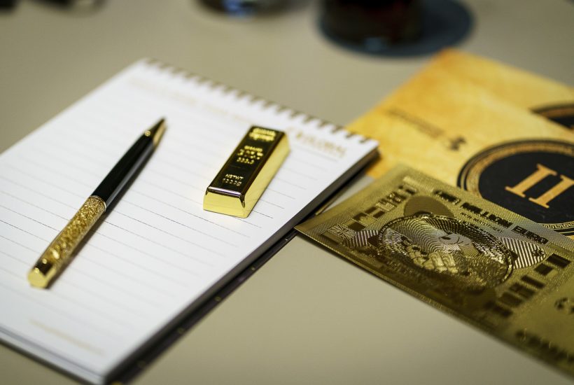 This picture shows a gold bar on top of a notepad.