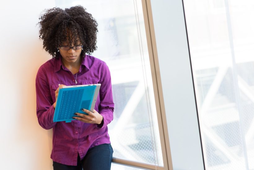 This picture shows a woman taking some notes.