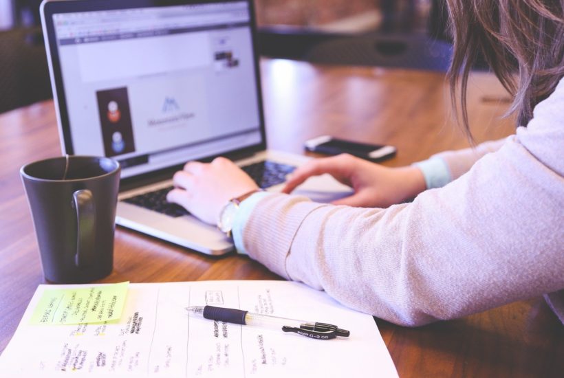 This picture shows a woman working on a laptop.