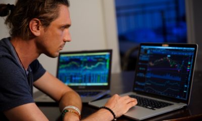 This picture shows a person looking at some stock market data.