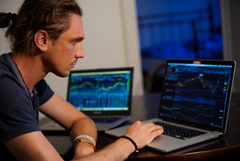 This picture shows a person looking at some stock market data.