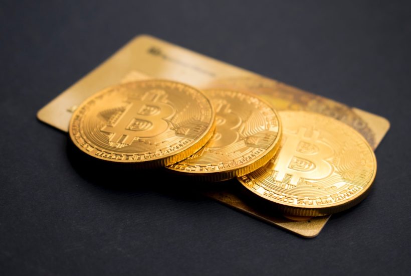 This picture shows a couple of bitcoins on top of a card.