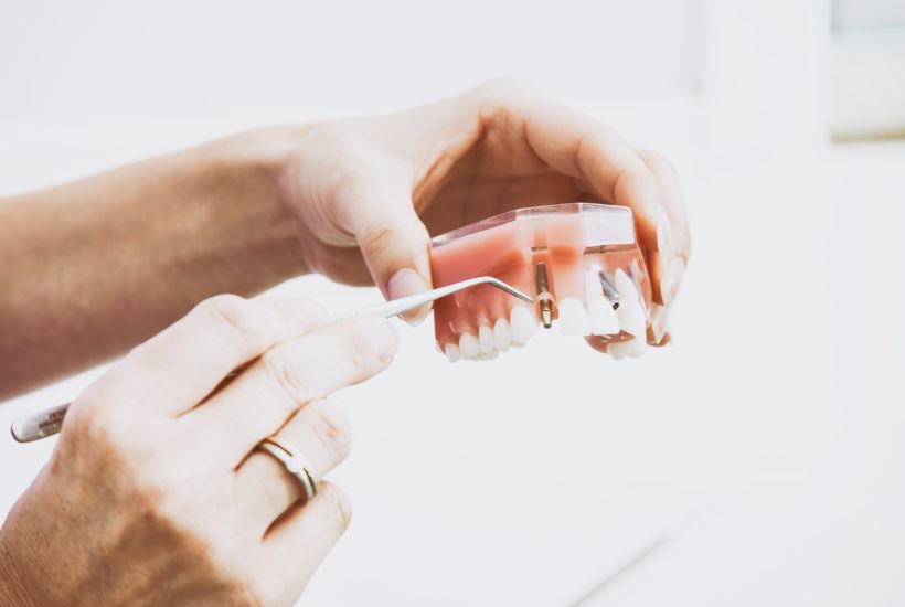 This picture show someone cleaning his prosthetic teeth.