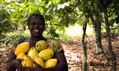 This picture show a woman holding some fruits.