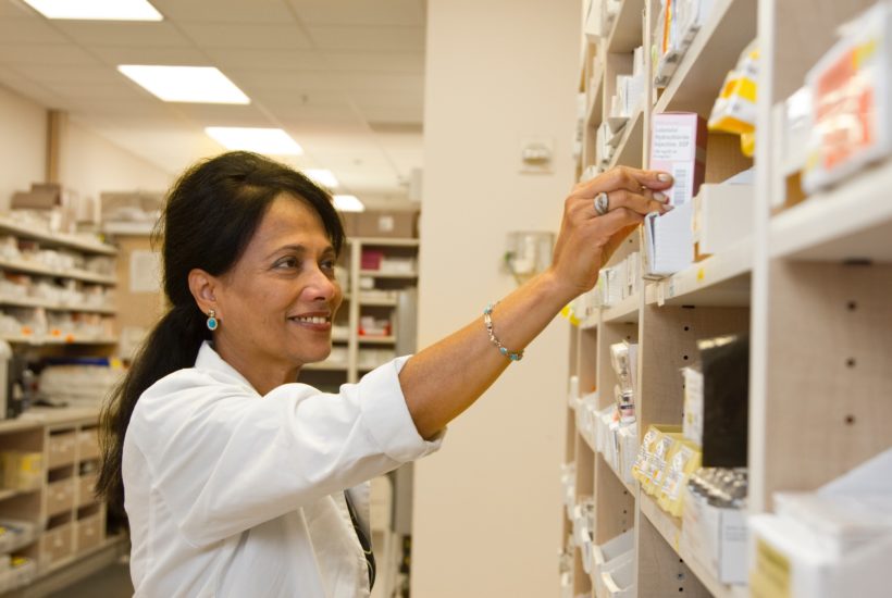 This picture show a person sorting medicines.