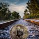 This picture show a bitcoin on a railroad.