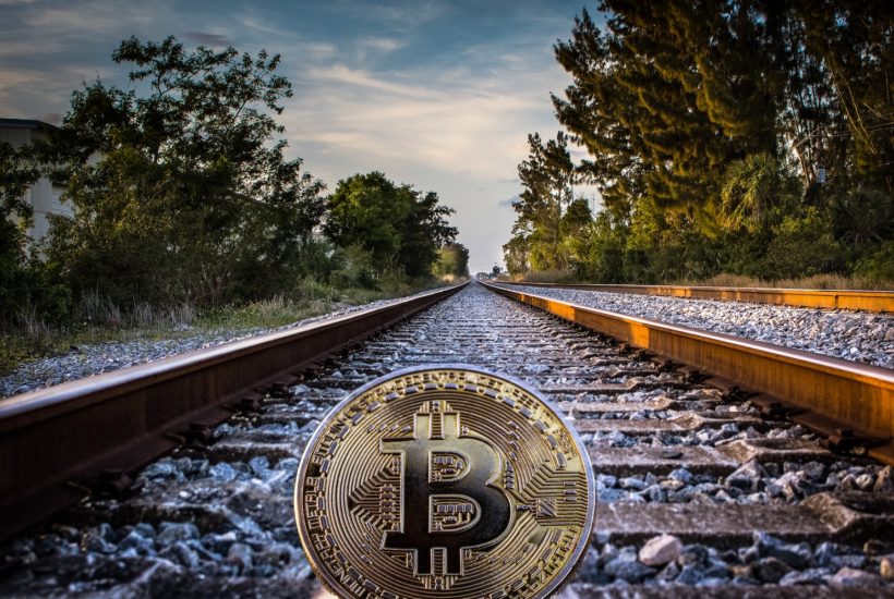 This picture show a bitcoin on a railroad.