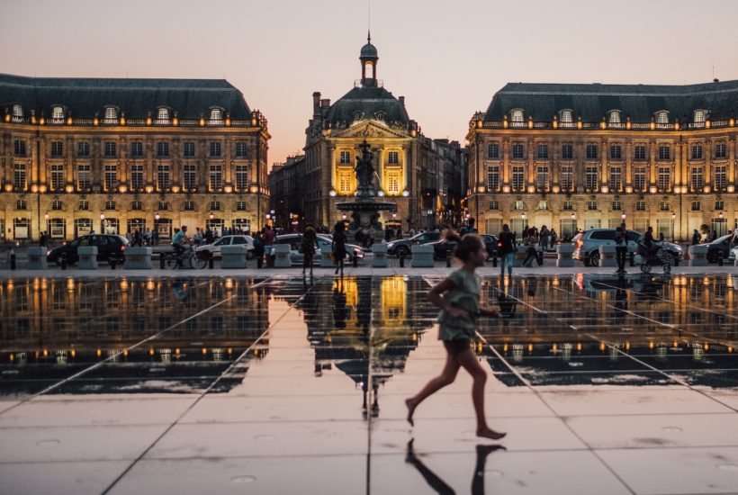 This picture shows a person walking in a city.