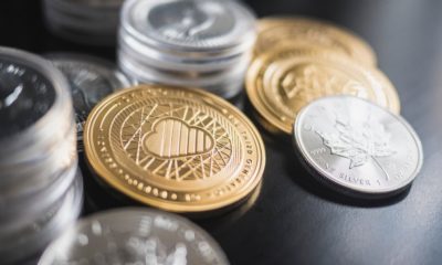 This picture shows a couple of crypto coins on top of a table.