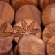 This picture show a couple of cannabis wooden coins.
