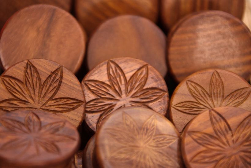 This picture show a couple of cannabis wooden coins.