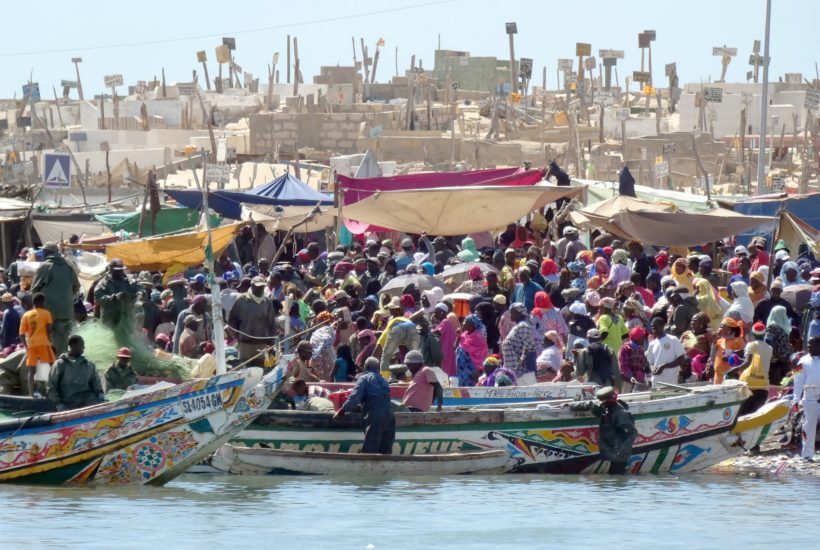 This picture show some african people on a boat.