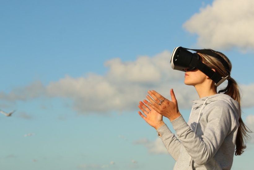 This picture show a woman using a VR set.