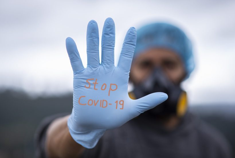 This picture show a doctor with a message in his gloves.