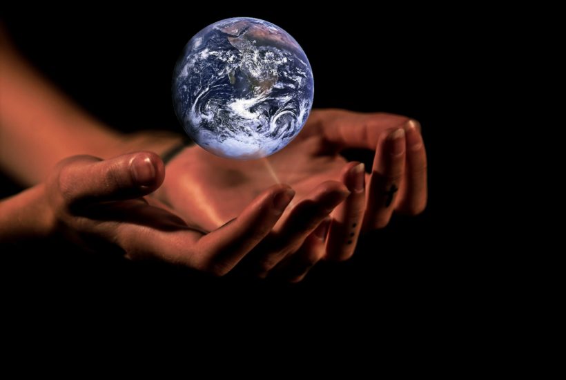 This picture show two hands holding a globe.