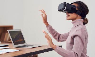 This picture show a woman using virtual reality.