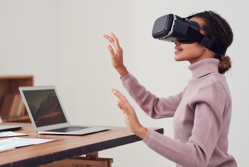 This picture show a woman using virtual reality.