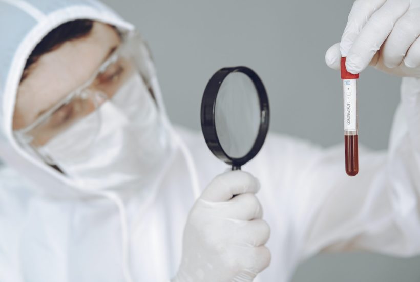 This picture show a scientist looking at a blood sample.