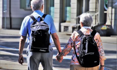 This picture show two eldery people holding hands.