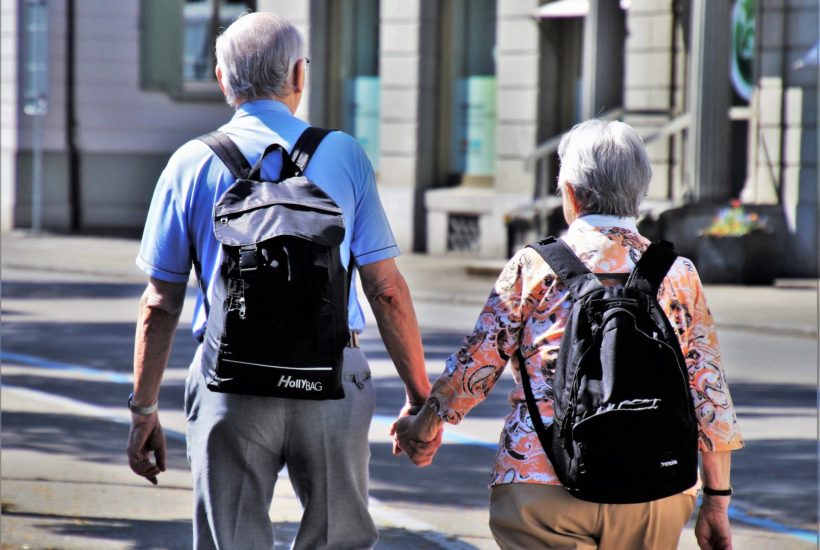 This picture show two eldery people holding hands.