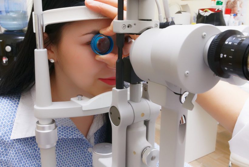 This picture show a person doing an eye exam.