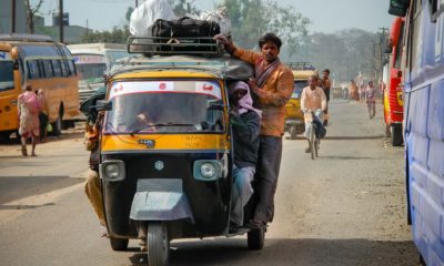 This picture show a person on a car in India.