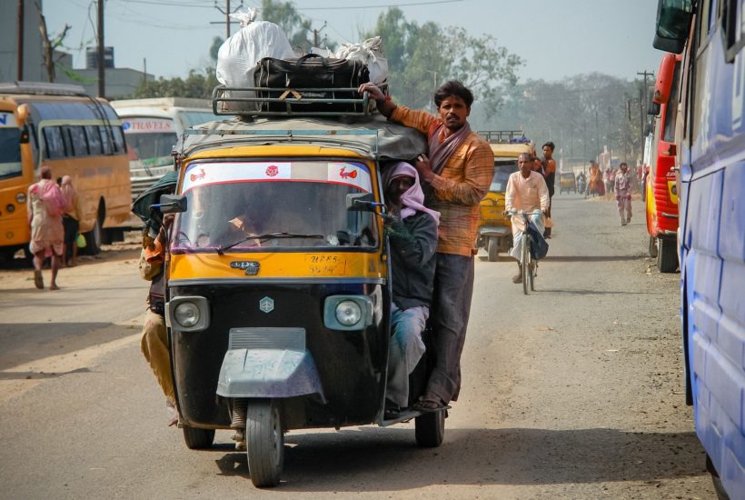 This picture show a person on a car in India.