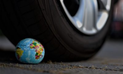 This picture show a tire on top of the earth globe.