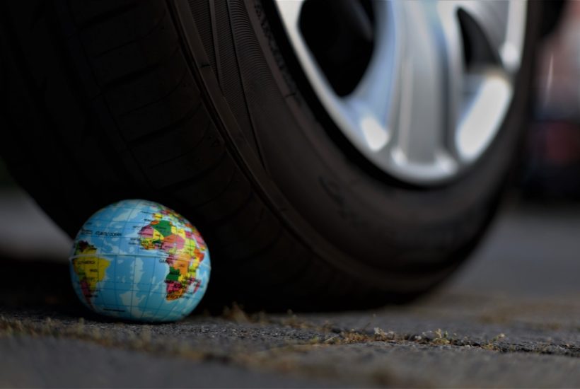 This picture show a tire on top of the earth globe.