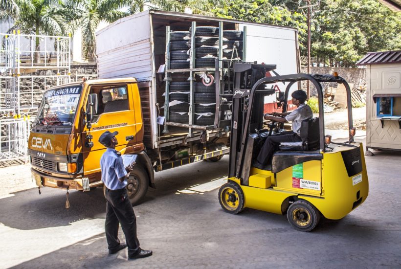 This picture show a person loading son stuff in a truck.