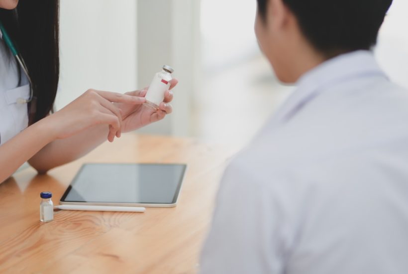 This picture show a doctor checking some medicines.