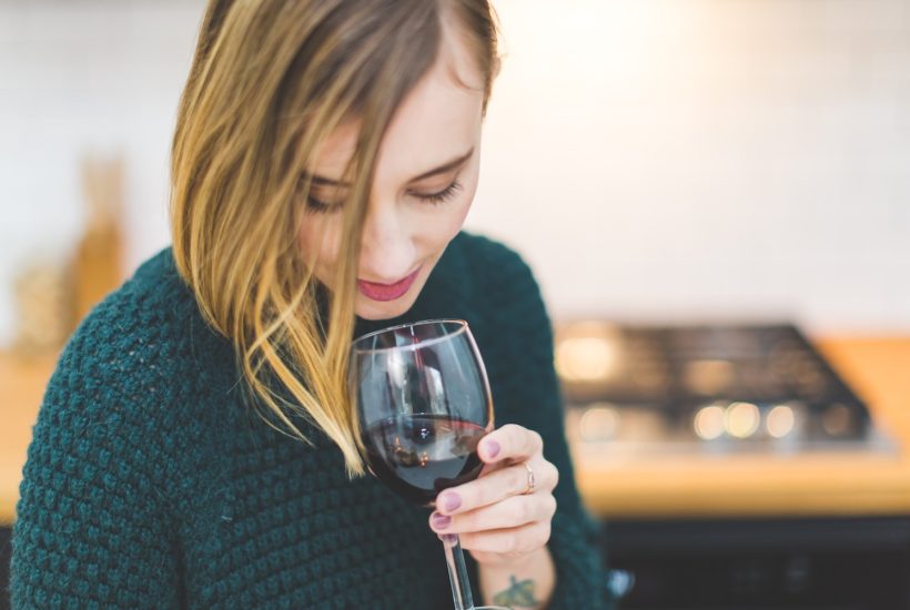 This picture show a woman drinking wine.