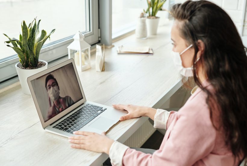 This picture show a person using a laptop during the pandemic.